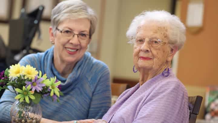 two senior women smiling together