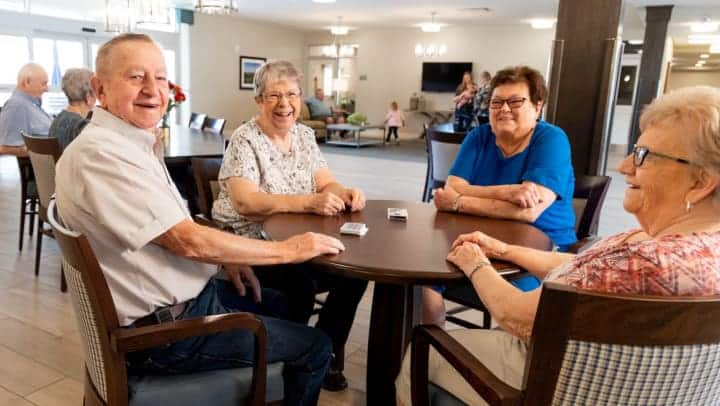 senior friends playing card game