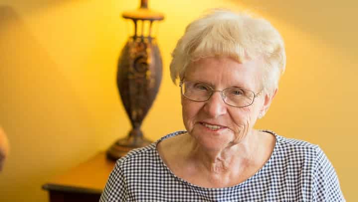 Senior woman smiling in her living room