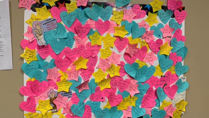 Heart-shaped and star-shaped post-it notes with words of praise and encouragement