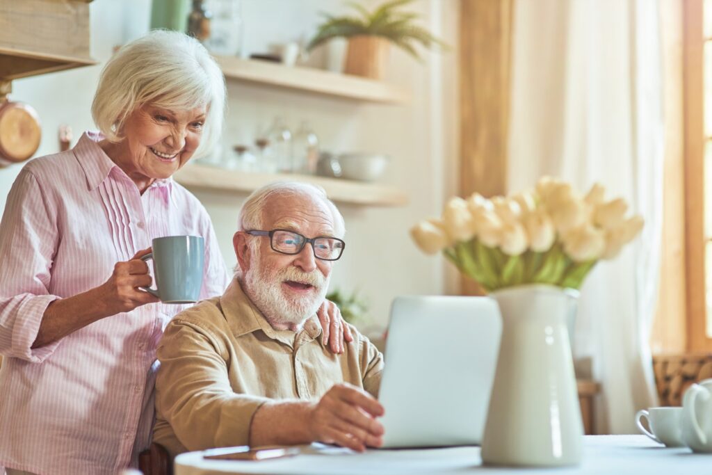 Senior couple reviewing their finances on a laptop