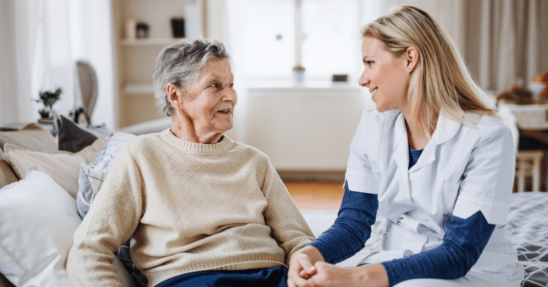 Older woman with dementia setting down speaking with on how to get support