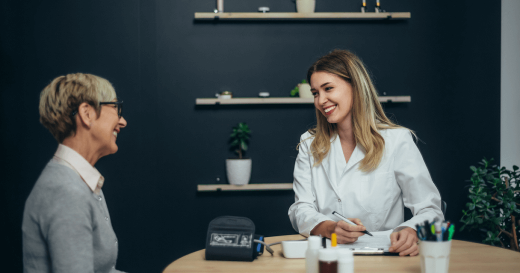 Adult daughter speaking to a women when visiting a senior living community