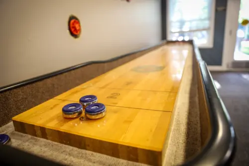 Heritage Pointe assisted living game room shuffleboard table