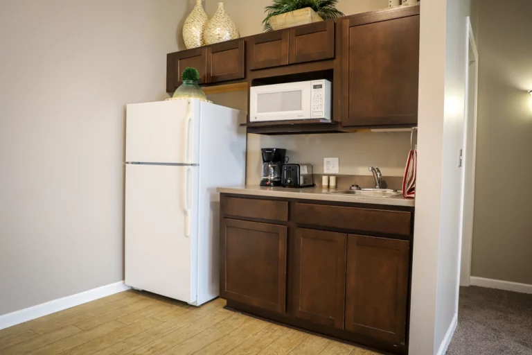 Heritage Pointe assisted living model apartment kitchenette with full size refrigerator/freezer