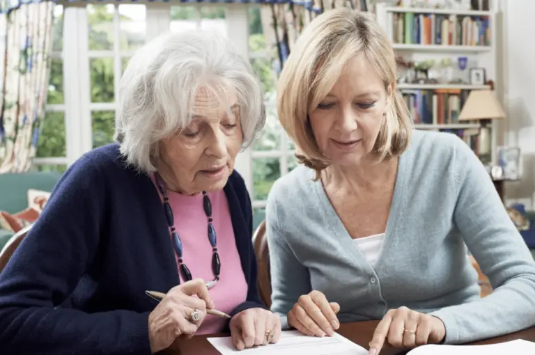 senior and caregiver looking at the benefits of assisted living