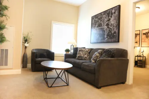 The Heritage at Fountain Point assisted living apartment couch, chair and table