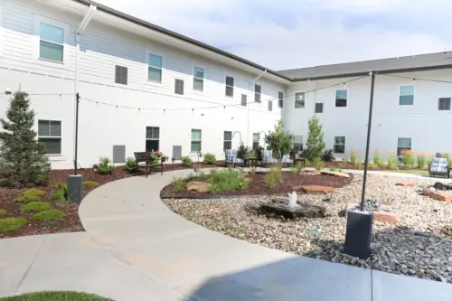 The Heritage at Fountain Point outdoor assisted living courtyard with string lights