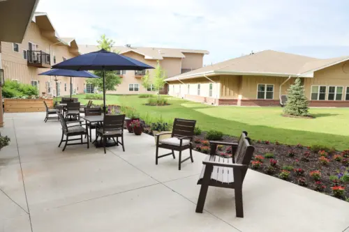 The Heritage at Fox Run independent living patio seating and raised gardens