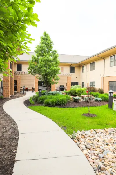 The Heritage at Legacy Secure outdoor assisted living courtyard with walking path