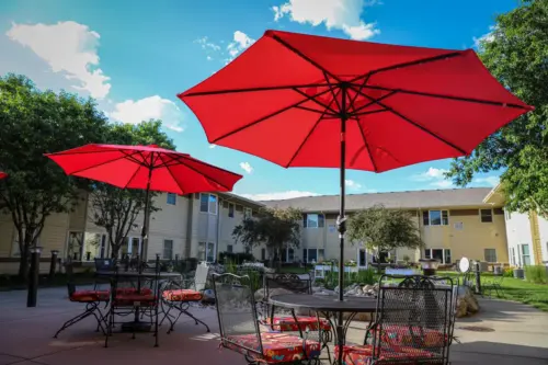 The Heritage at Meridian Gardens senior living secure outdoor courtyard with seating and shade