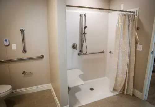 Orchard Point at Creek Valley assisted living apartment bath with walk-in shower and seat