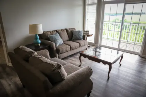 Ridgewood Senior Living independent living apartment living room with balcony