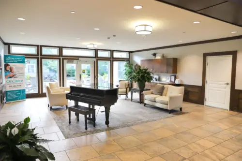 The Heritage at Sterling Ridge lobby with piano and chairs