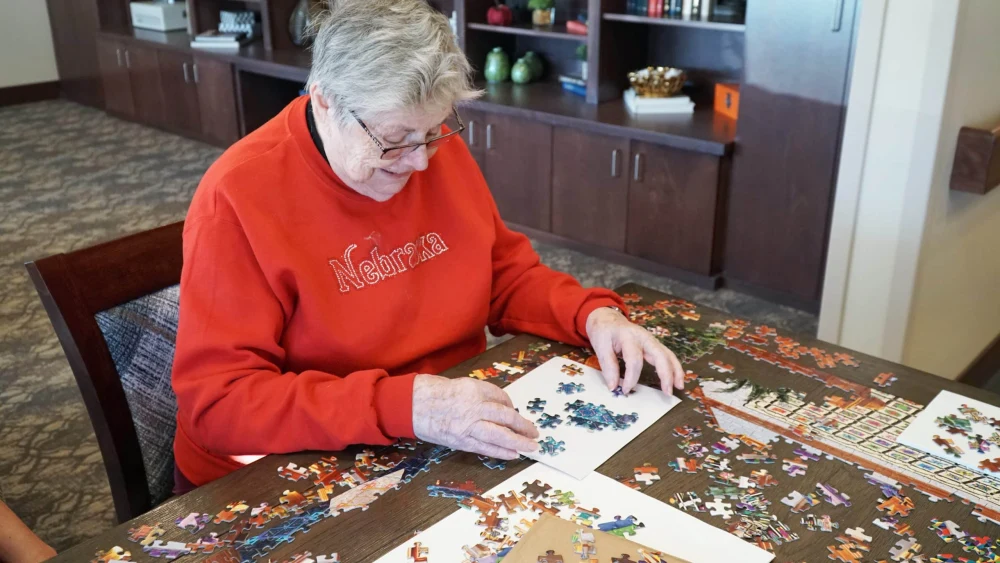 senior completing a puzzle in memory care