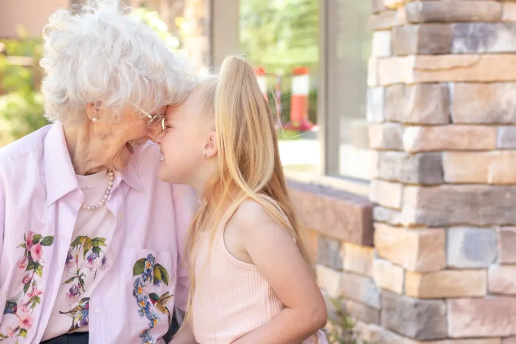 a senior in assisted living visiting with her granddaughter